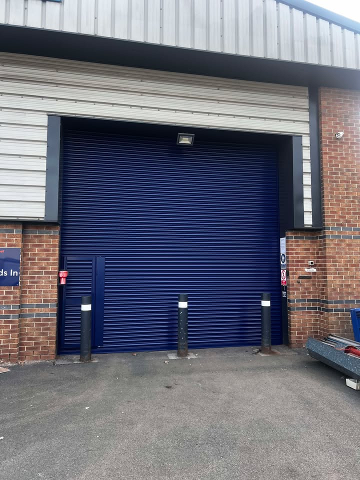 Industrial blue roller door installation by LNR Door Solutions