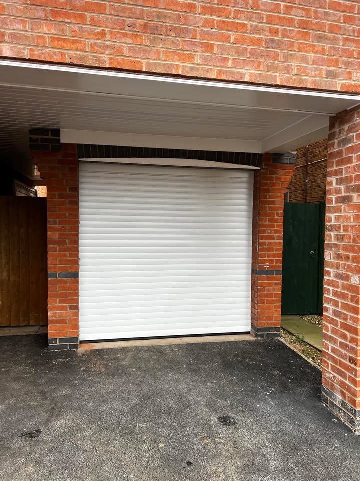 White garage door with brick surround