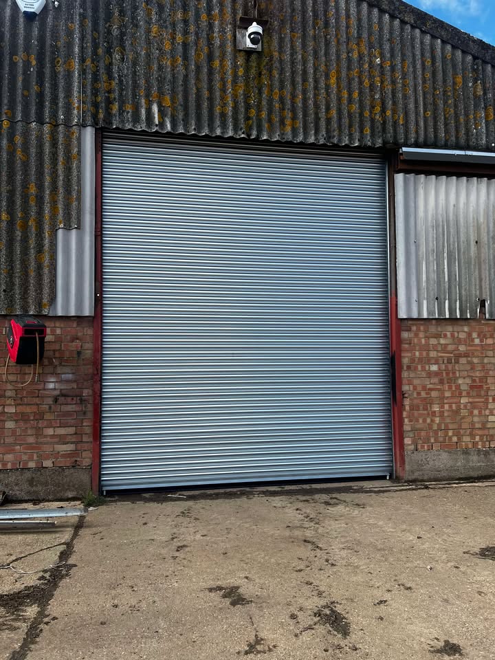 Farm building roller shutter with metal surrounds