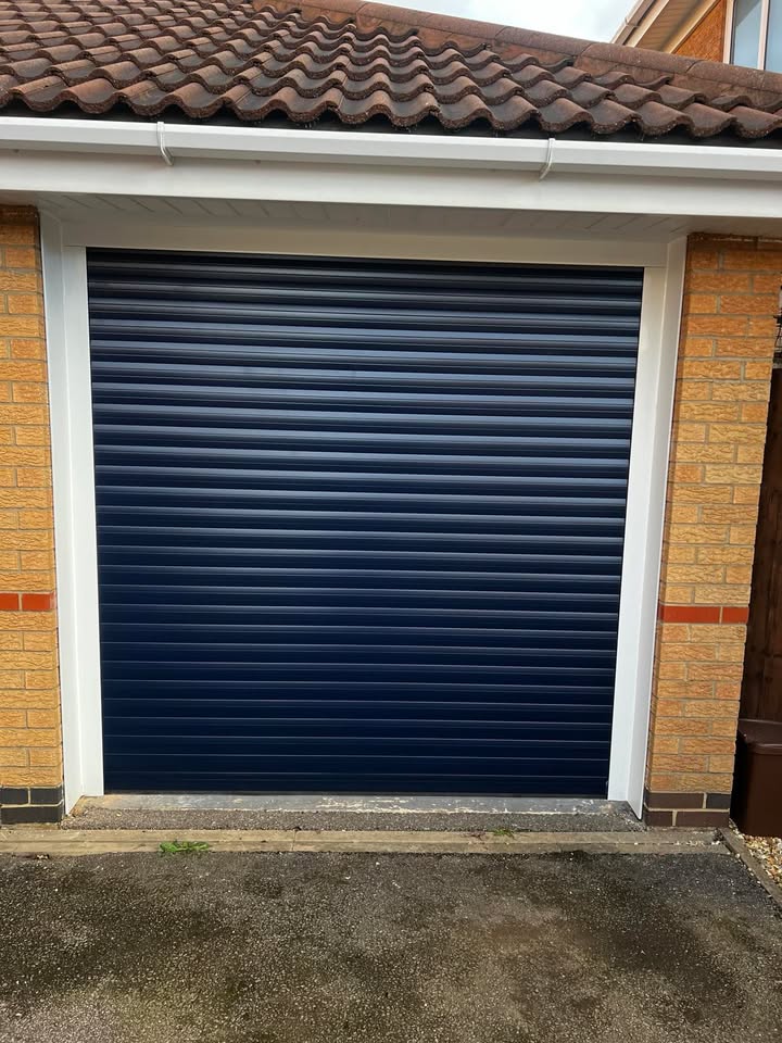 Navy blue garage door with white trim