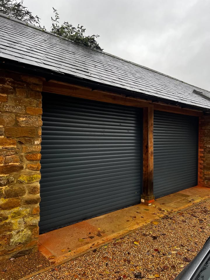 Double garage roller doors with stone walls