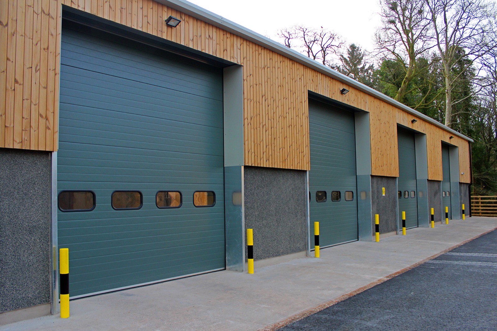 Modern sectional overhead doors with steel hinged personnel access doors
